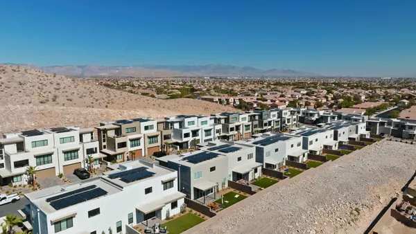 A series of homes at the base of a mountain,