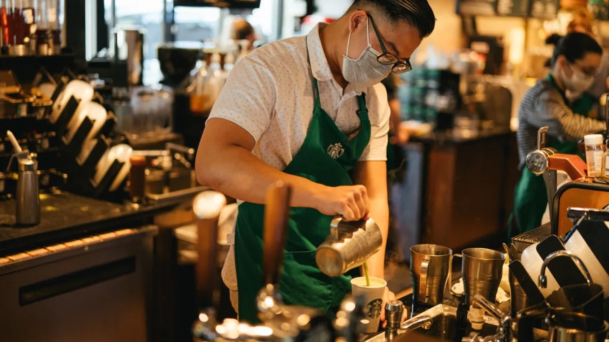 A Starbucks employee wears a mask after a store reopens amid the novel coronavirus pandemic in 2020.