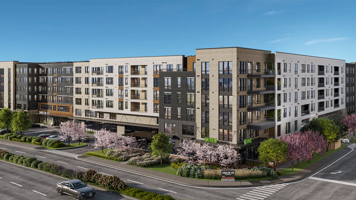 The exterior of a mid-rise modern apartment building with light cladding.