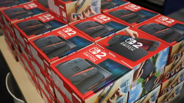 Packaged Nintendo Switch 2 consoles in boxes are displayed on a table.