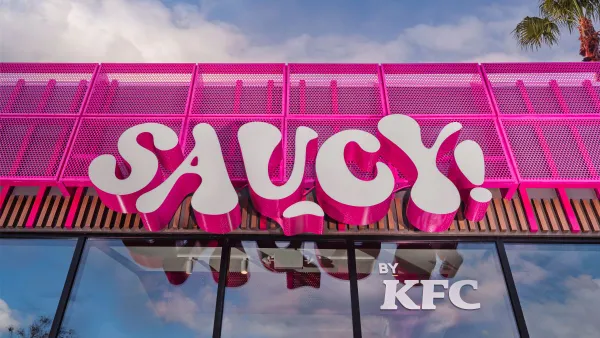 An image of a pink sign that says "Saucy"