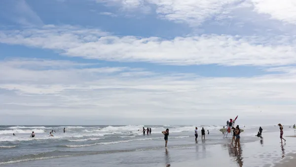 A group of people swim and play at a beach as a lifeguard watches in Wildwood, New Jersey, during Memorial Day weekend in 2023.