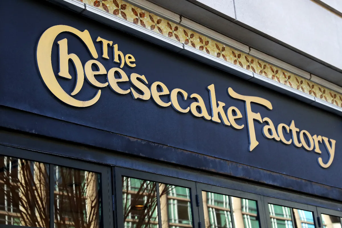 An image of a black building with windows and The Cheesecake Factory signage.