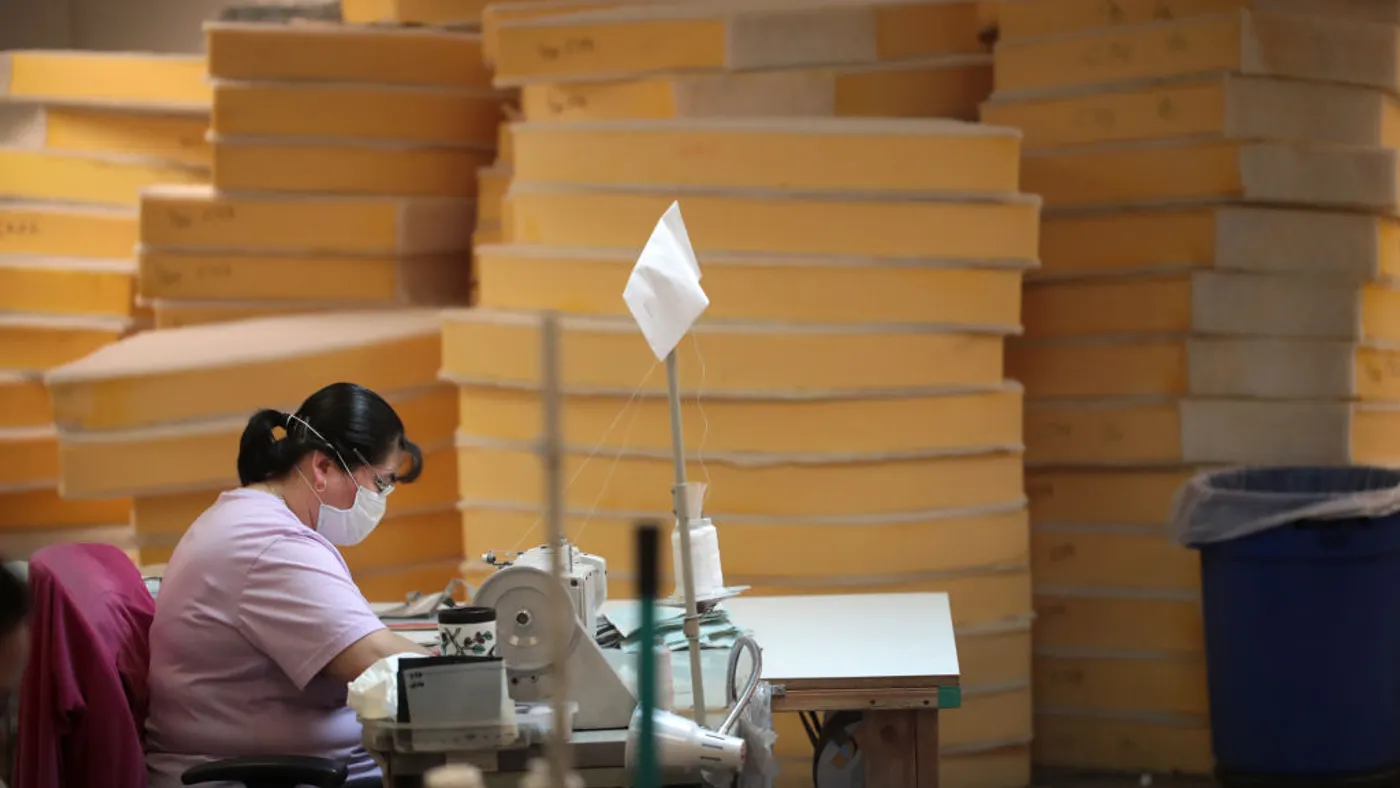 A worker at NorthCape, an outdoor furniture manufacturer, sews personal protective equipment on March 30, 2020 in Alsip, Illinois. Covid-19 has transformed how manufacturers operate five years later.