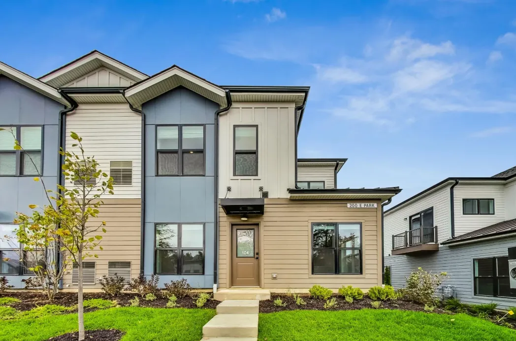 A single family home surrounded by a green yard