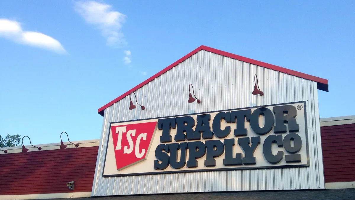 A Tractor Supply storefront on a sunny day with a blue sky.