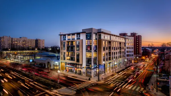 Aerial picture of a modern apartment property at dusk.