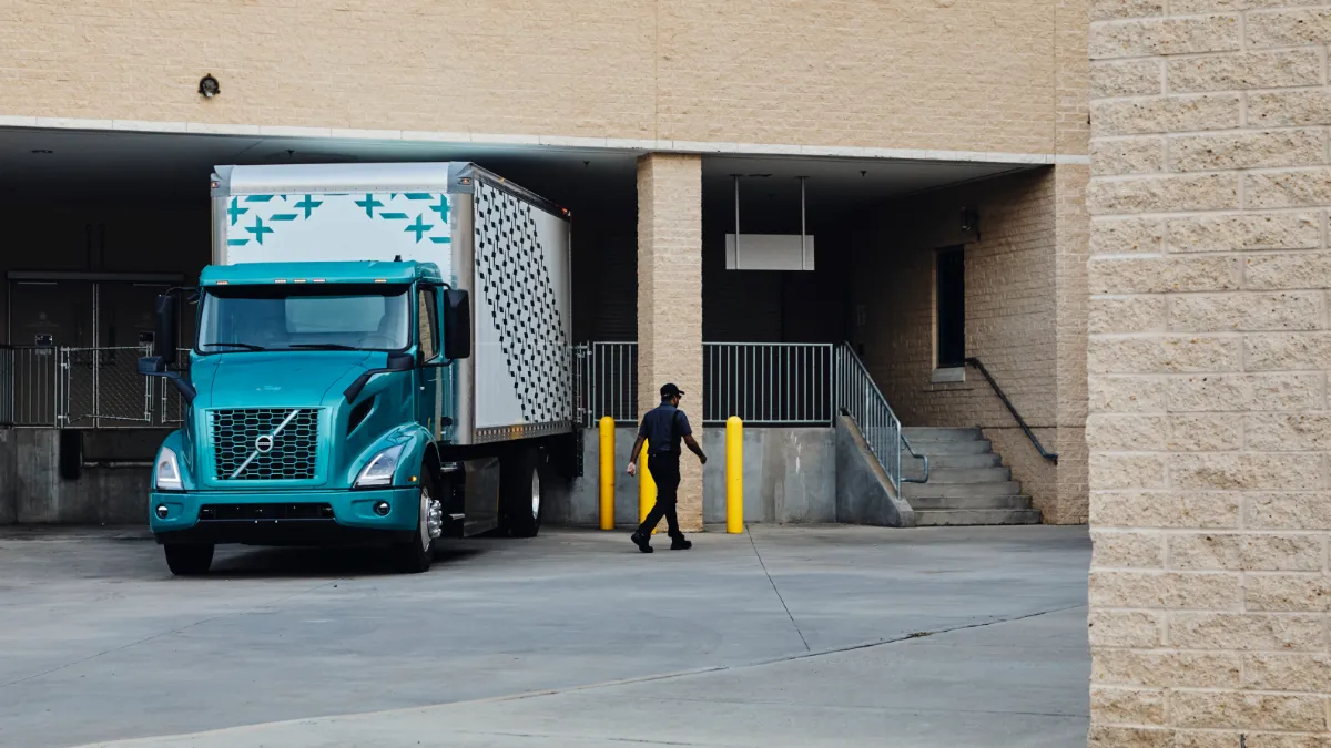 A driver walks away from a Volvo electric truck