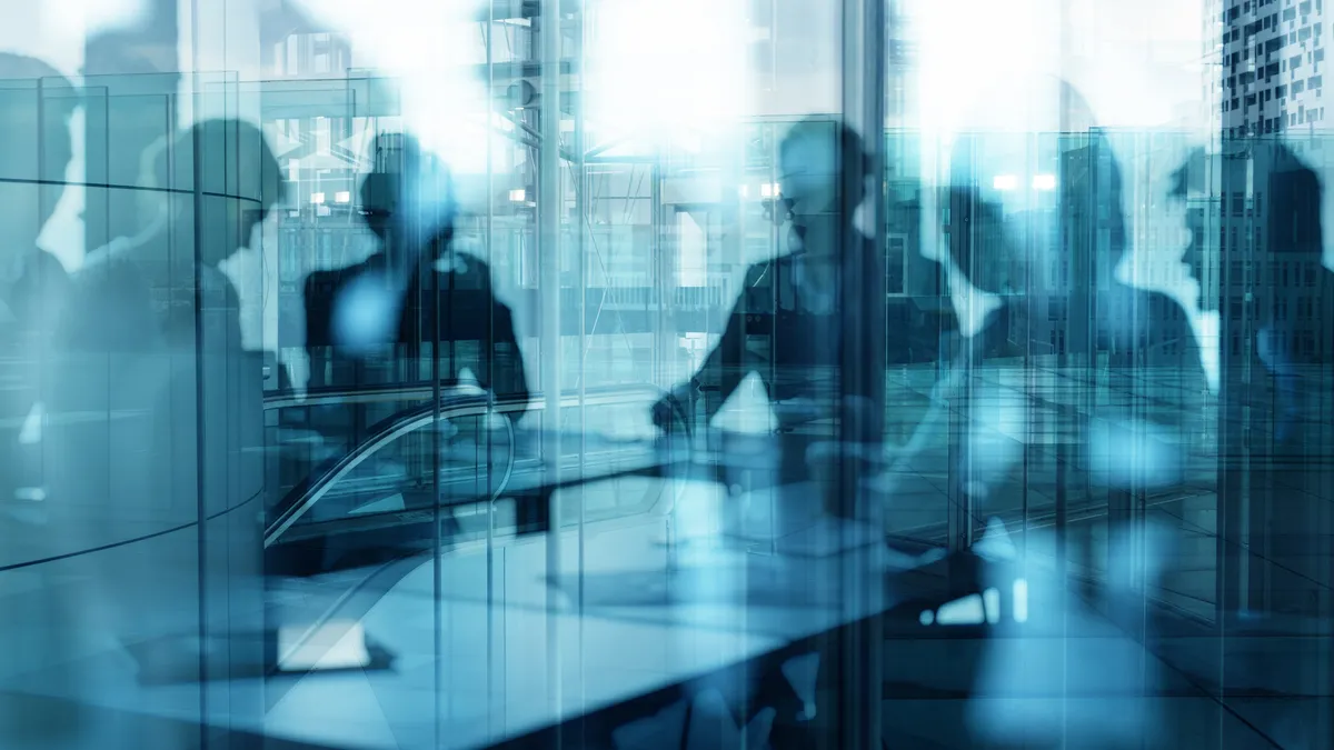 a group of people in a meeting room