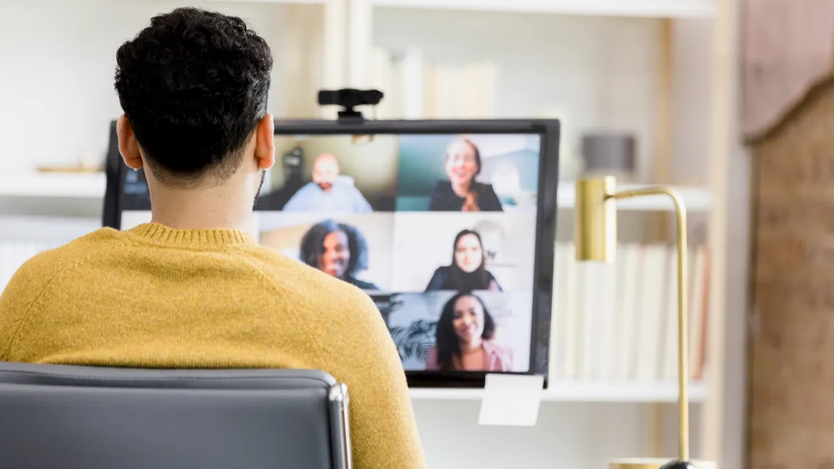 Man attending a video conference call with his team