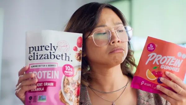 An actor holds up Purely Elizabeth's new protein product alongside a pack of protein gummy candies