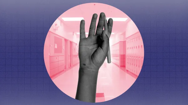 A composite of a circle cut out with a school hallway that frames a raised hand holding a pen.