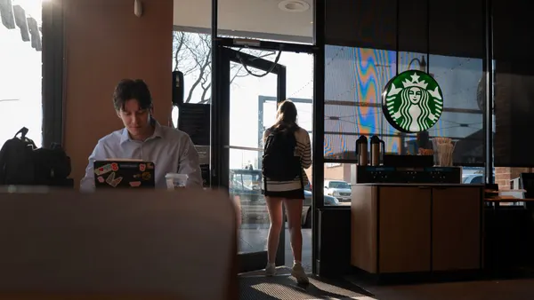 A customer works on a computer inside a Starbucks location.