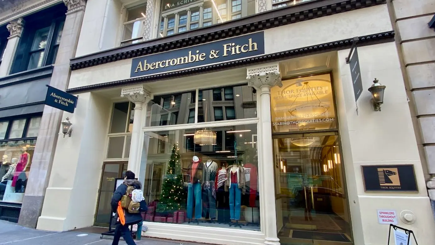 A person walks past a clothing store.