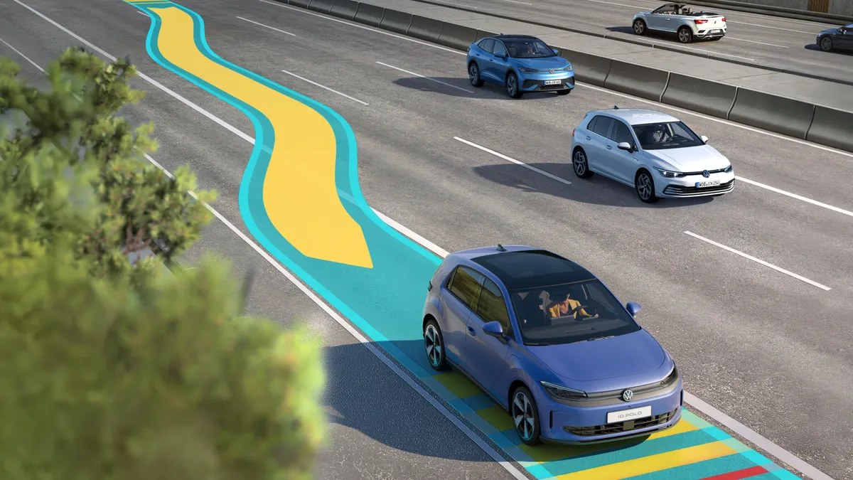 A rendering of a Volkswagen ID.Polo driving on a highway showing blue and yellow graphics depicting the vehicle being guided to the shoulder.