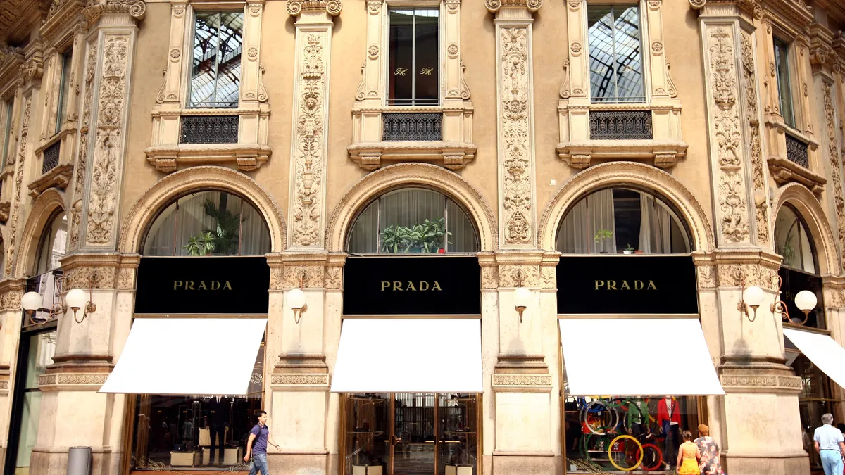 Ornate and elaborate old Italian building housing the Prada storefront in Milan as seen during the daytime.