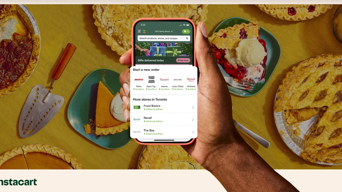 Photo illustration of hand holding a phone with the Instacart app open against the backdrop of a Thanksgiving table