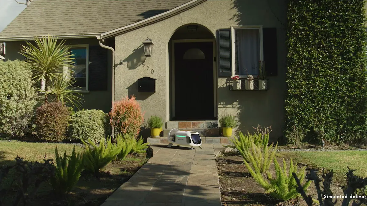 A Zipline delivery droid in front of a house.