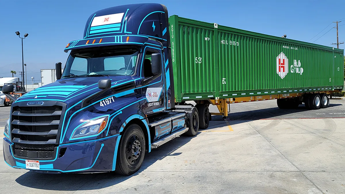 A Freightliner eCascadia with a Hub Group container