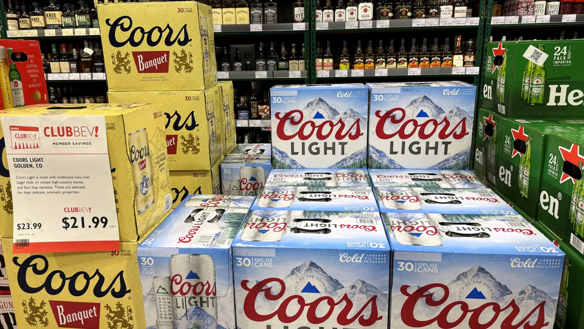 Cases of Coors Banquet and Coors Light are displayed next to each other in a store.
