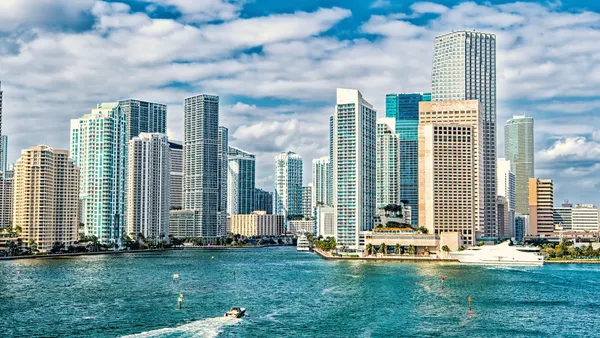 iami skyline. Yachts sail on sea water to city - stock photo.