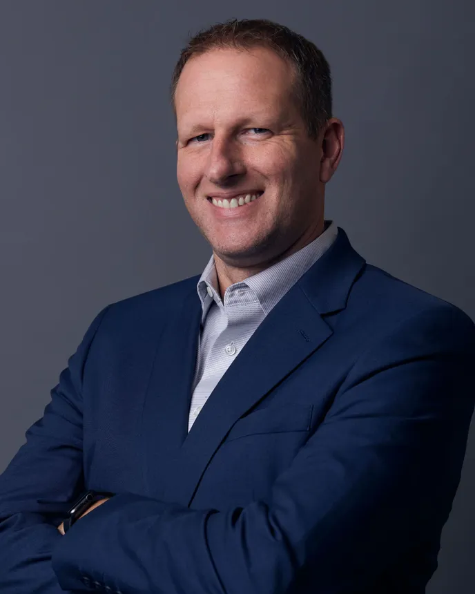 Headshot of a man in a suit.