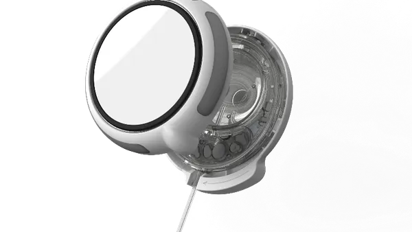 A white, rounded device is open showing clear tubing inside.