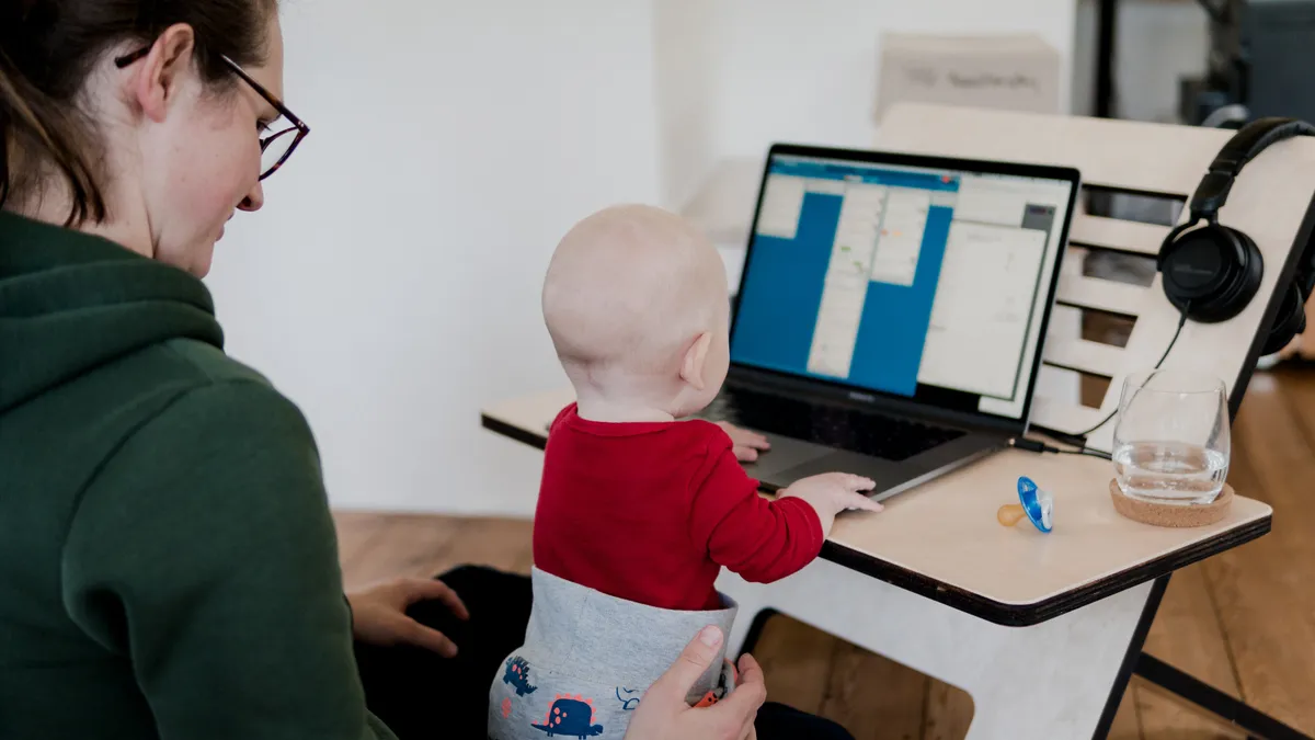 A parent with child as they work from home.