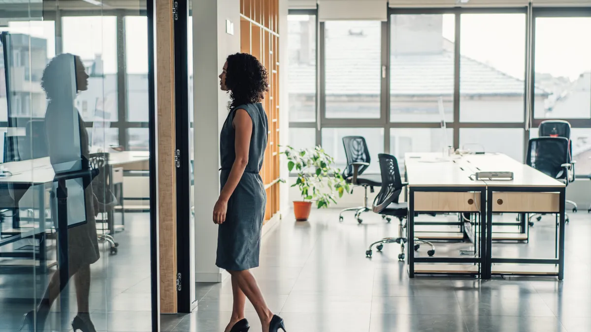 Businesswoman walking in modern office.