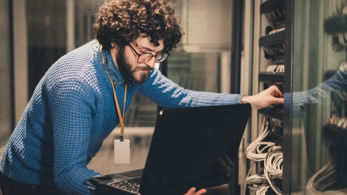 An engineer works on the servers at his office