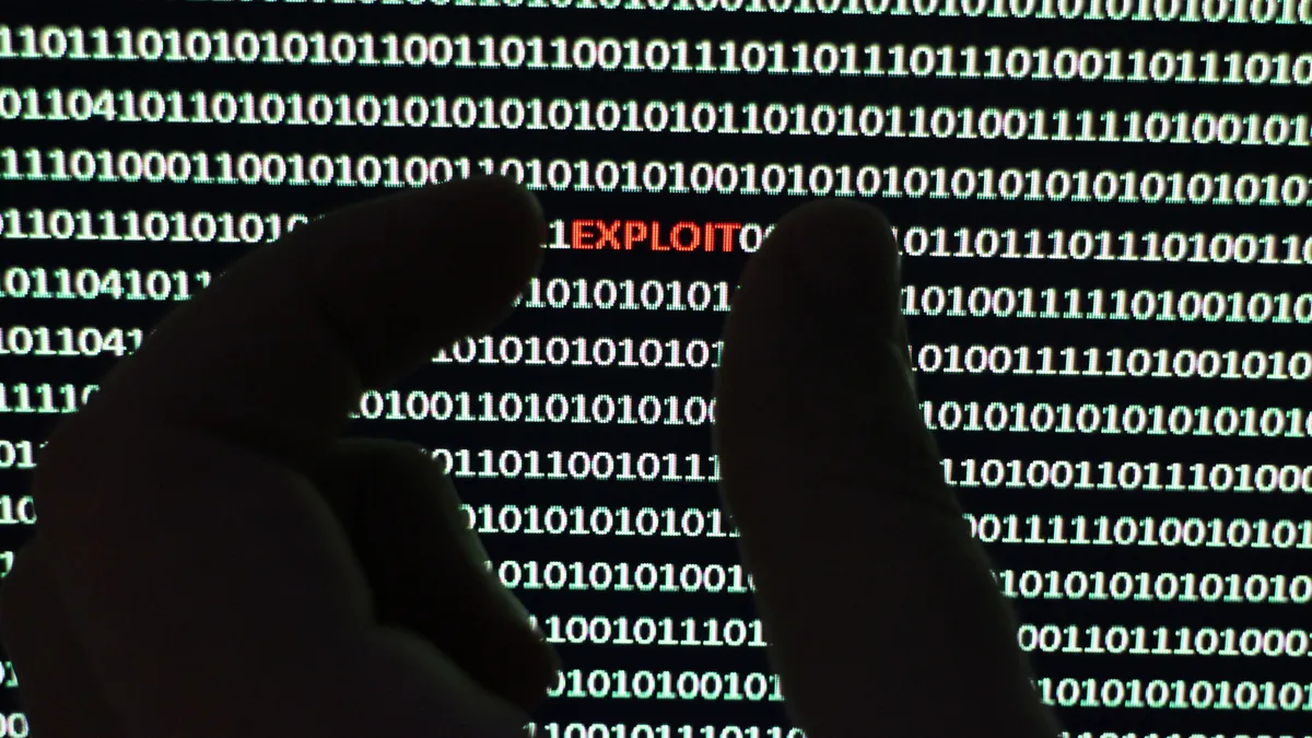 Photograph depicts a security scanner extracting virus from a string of binary code.