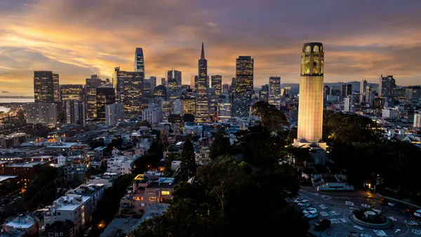 A picture of San Francisco's Coit Tower and downtown at dawn.