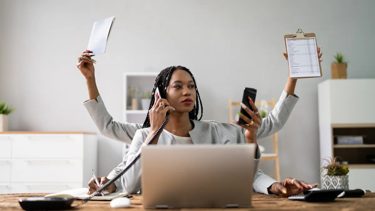 A person works from home with multiple arms sticking out of them