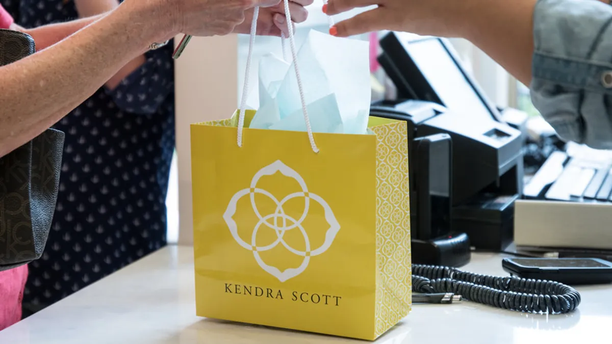 A small, bright yellow shopping bag sitting on a counter.