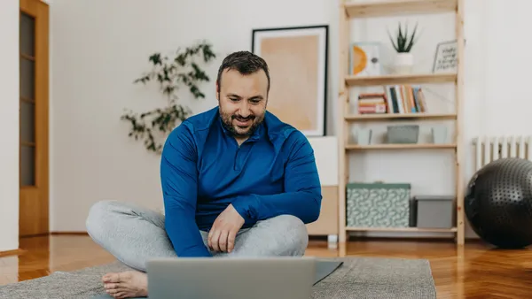 Man working out with an online trainer