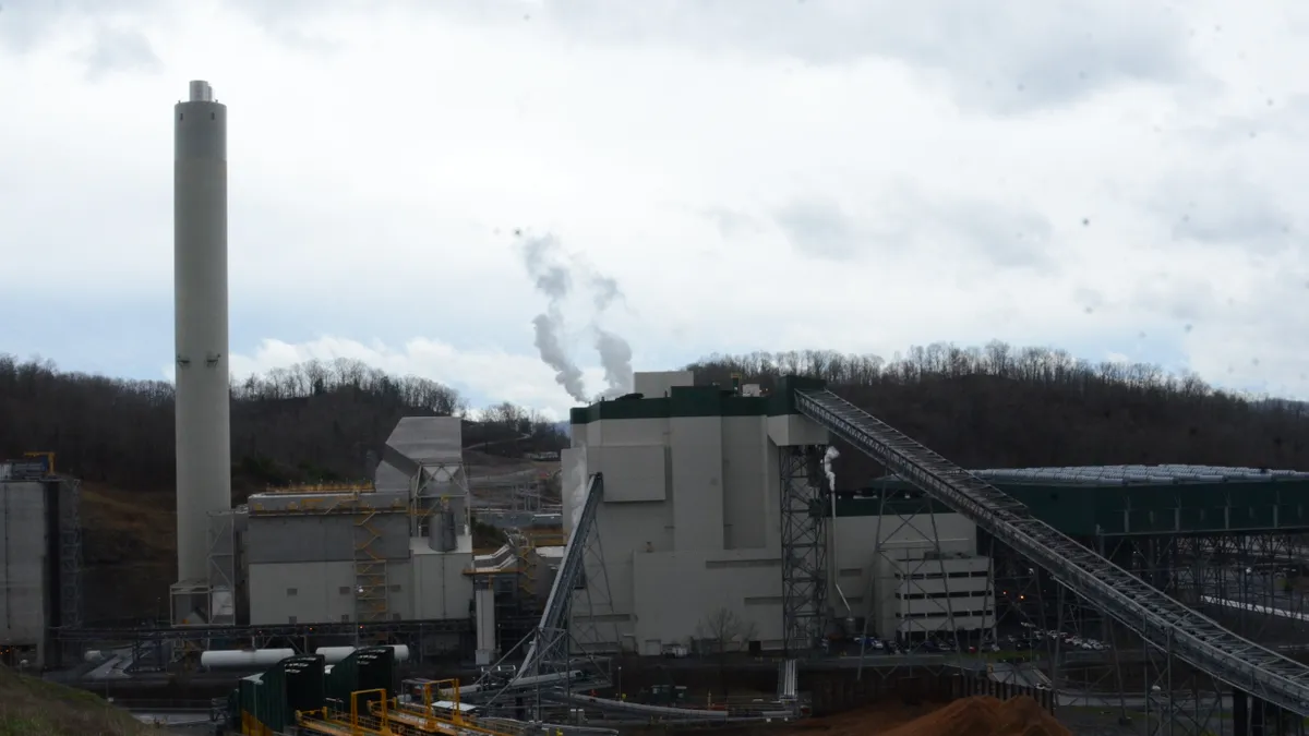 Exterior view of the Dominion Energy Virginia City Hybrid Energy Center, showing coal transportation belt, fuel mixing and a smokestack