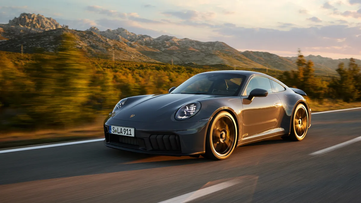 A Porsche vehicle driving down a road