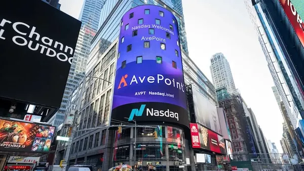 The corporate logo for tech company AvePoint is picture above the Nasdaq logo on a building sign in New York City.
