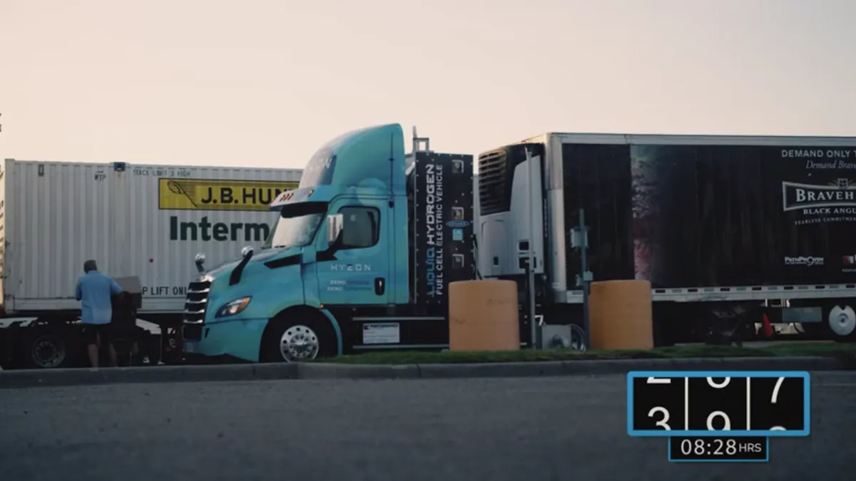 A Hyzon liquid nitrogen truck next to a J.B. Hunt intermodal container.