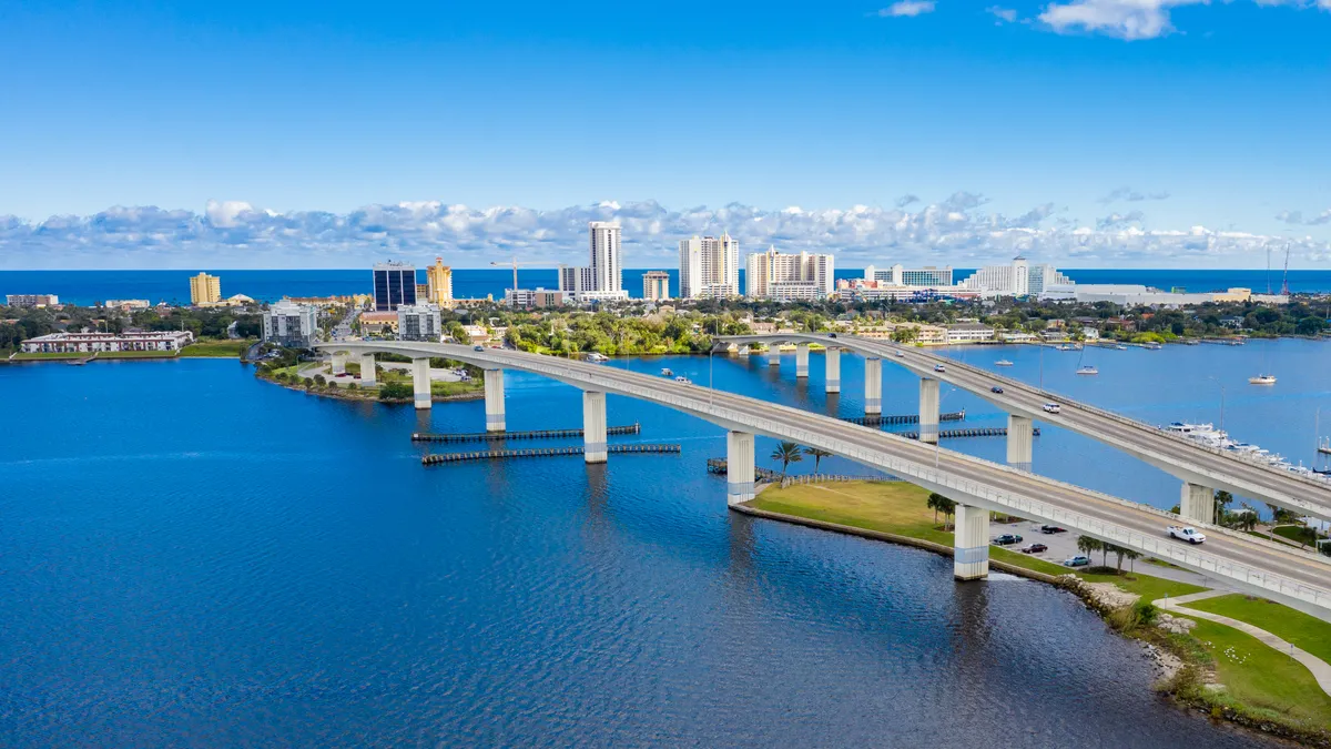 Drone angle view of Daytona Beach skyline and bridges over the intracoastal waterway.