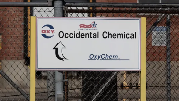 A white sign with "Occidental Chemical" in black text and "OxyChem" in blue text underneath it.