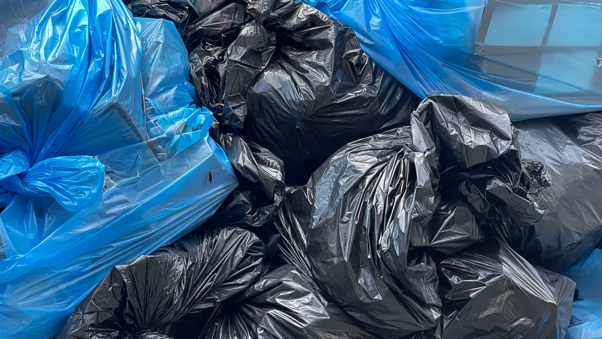 A closeup of blue and black garbage bags