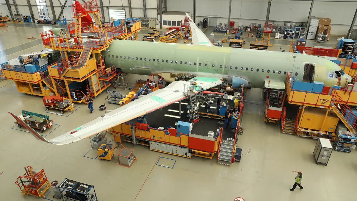 Airbus jet under production at factory.