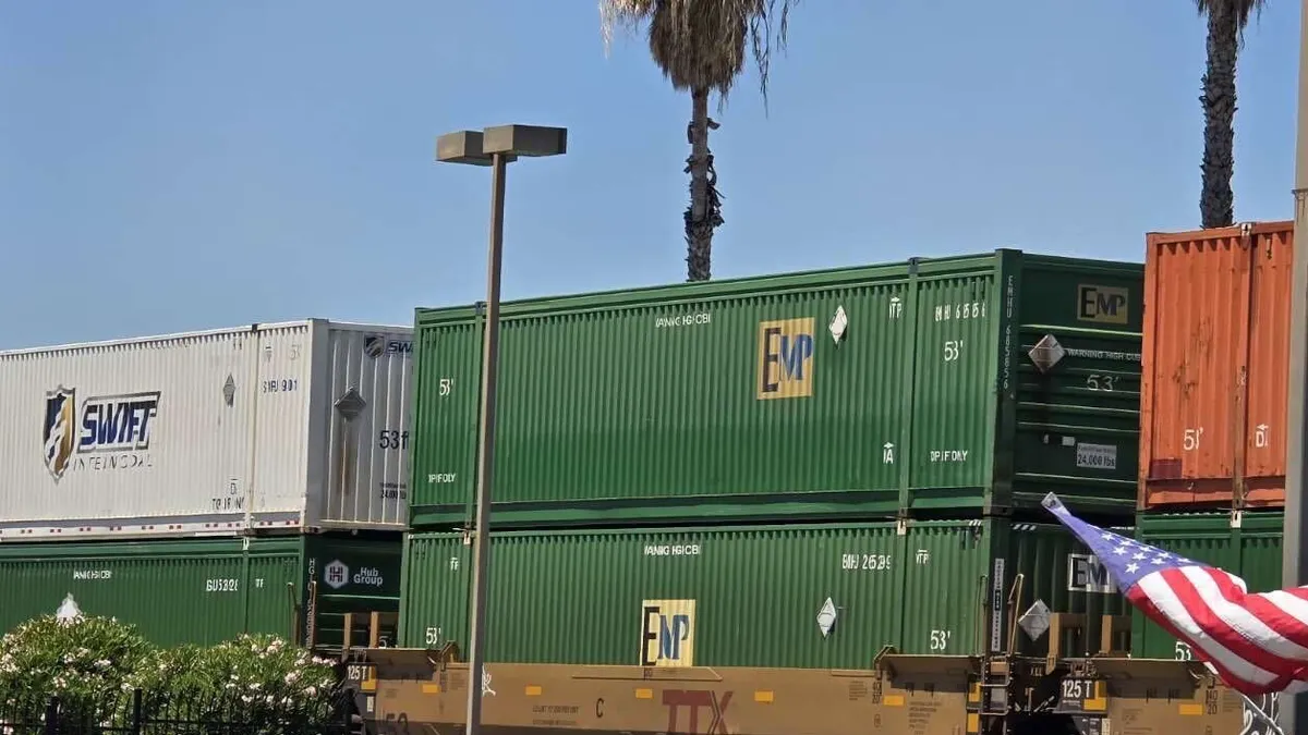 A row of containers onboard a rail train.