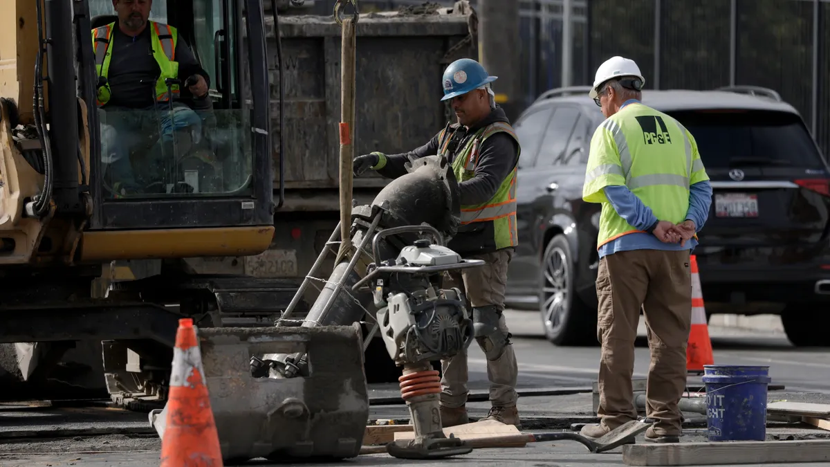 workers make repairs to an underground pipe