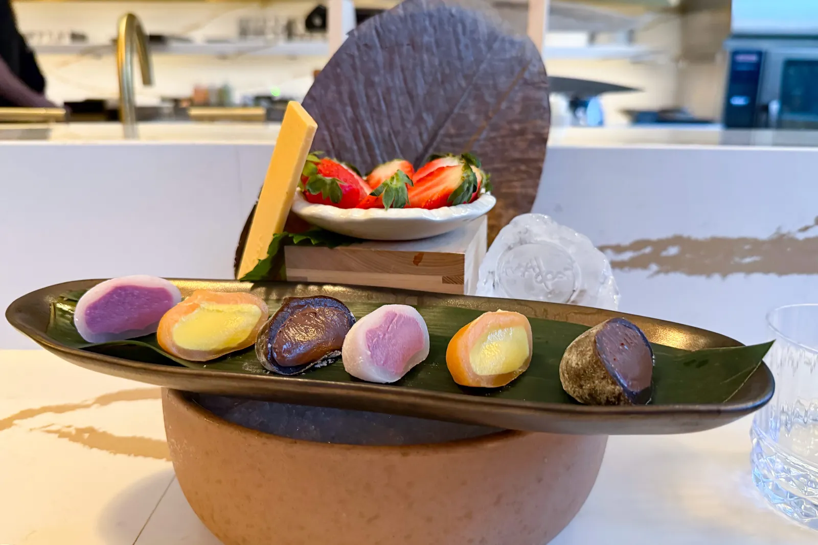 Mochi and fruit platter at a restaurant.