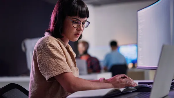Professional IT worker working late, coding and machine learning working with AI.
