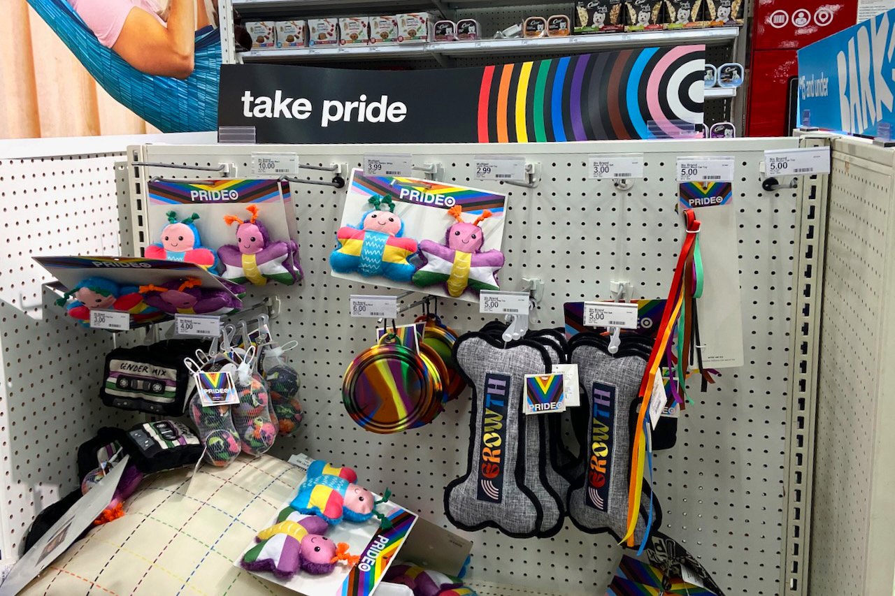 A shelf of pet toys featuring a Pride Month selection.