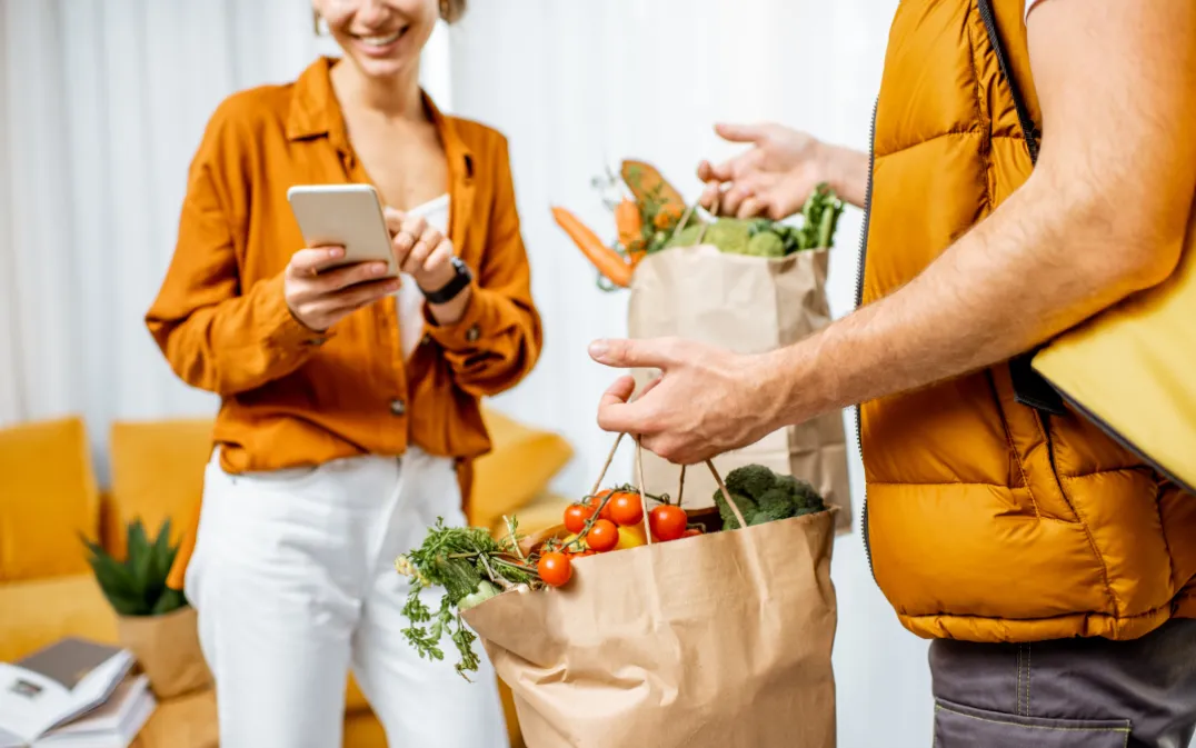 Courier delivering groceries to home