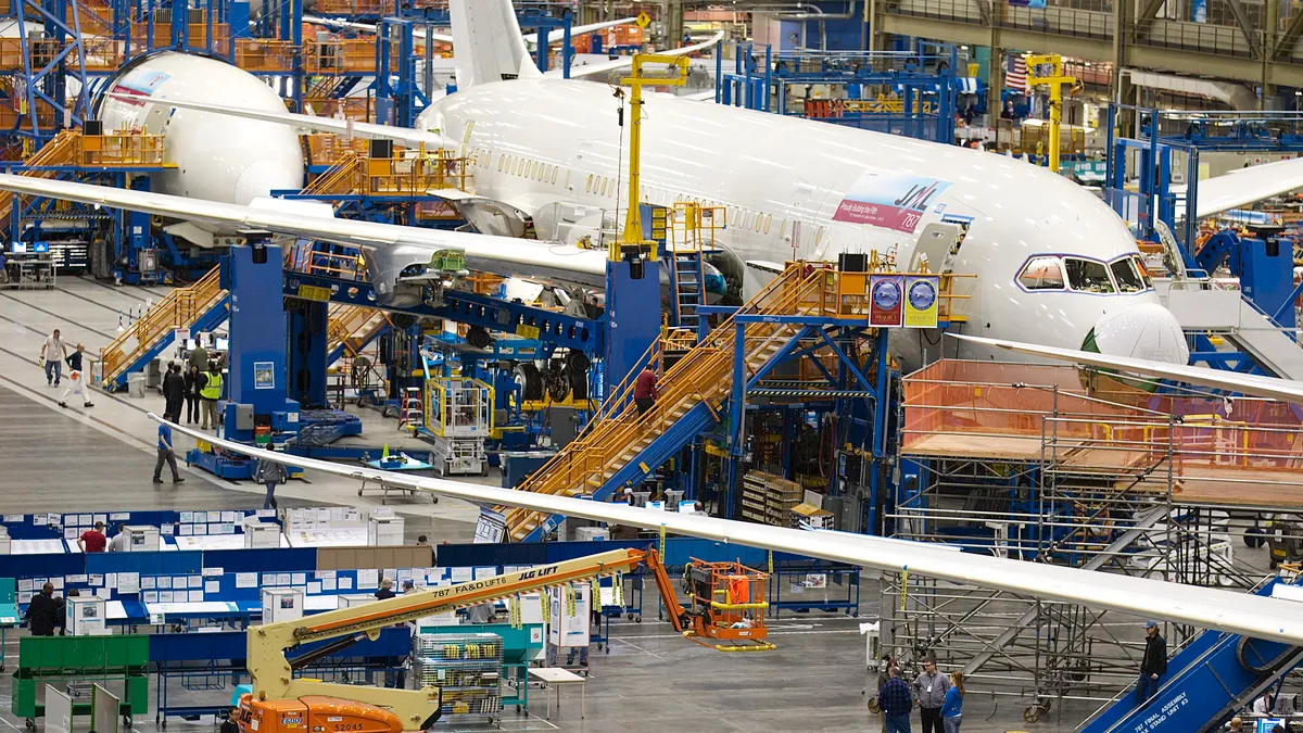 Boeing employees work on a Boeing 787 Dreamliner on one of the assembly lines February 14, 2011 at the company's factory in Everett, Washington.